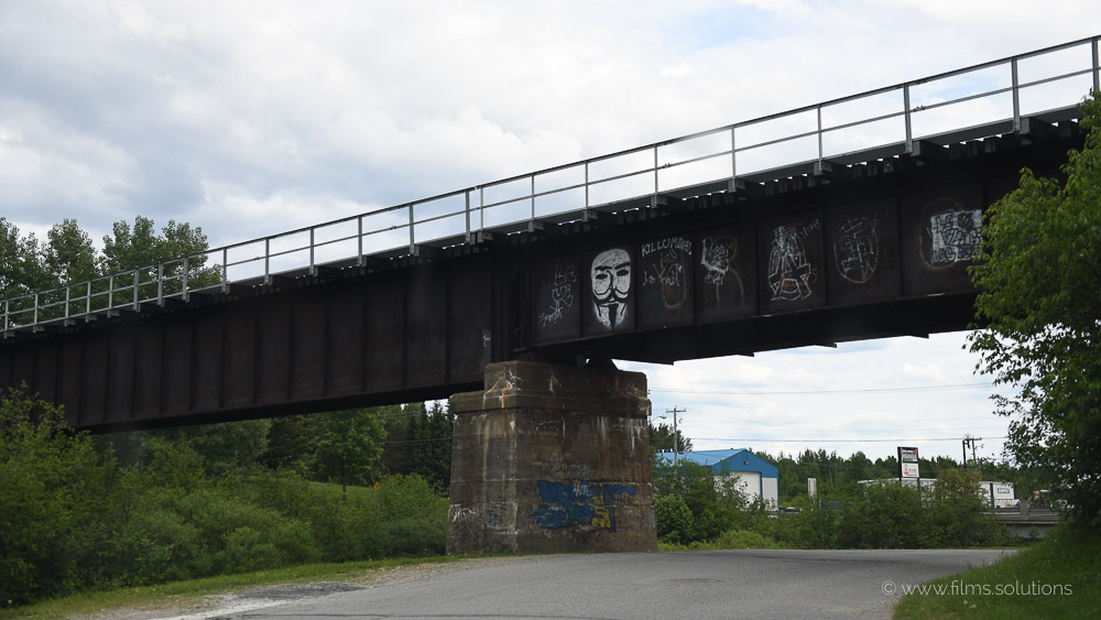 Quebec film locations - Train Bridge passing over a street in a small village in northern Quebec - Filming in Quebec means being surrounded by those beautiful scenery
